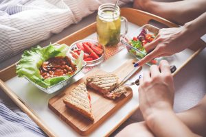 Young Woman Enjoying Morning Breakfast in Bed