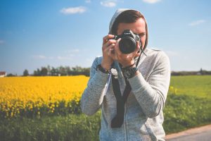 Young Photographer in Action Taking a Photo