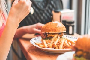 Woman Preparing to Eat Big Bacon Burger