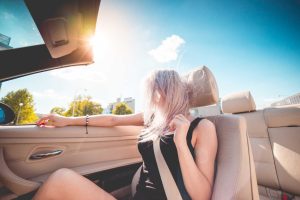 Young Blonde Girl on Summer Ride in Convertible